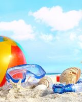Fun day at the beach with goggles and beach ball