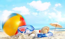 Fun day at the beach with goggles and beach ball