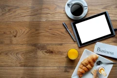 Breakfast with digital tablet on a wooden background with space